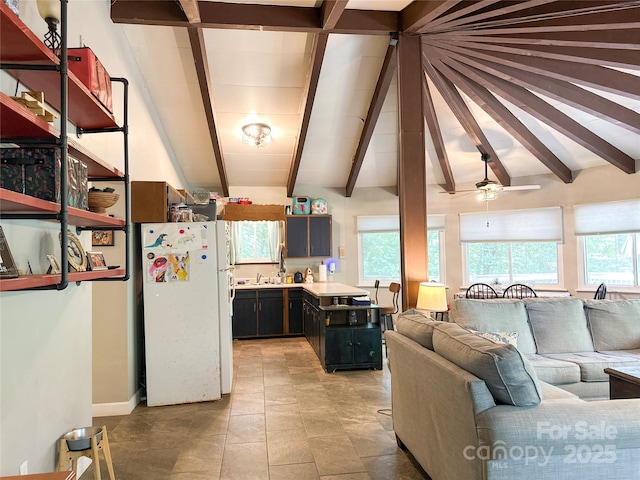 171 Windy Hill Dr, Franklin, NC 28734 - kitchen with freestanding refrigerator, beam ceiling, healthy amount of natural light, open floor plan, and dark cabinetry