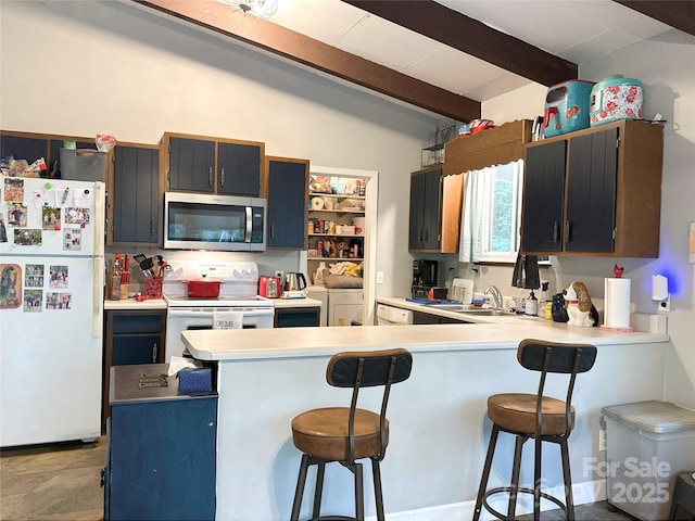171 Windy Hill Dr, Franklin, NC 28734 - kitchen with white appliances, a peninsula, a breakfast bar area, and light countertops