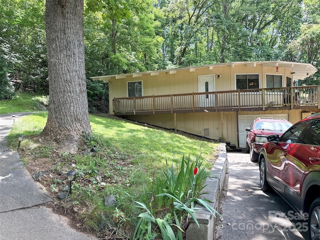 171 Windy Hill Dr, Franklin, NC 28734 - view of front of house featuring a garage, a wooden deck, and a front yard