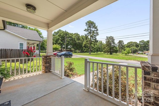 5305 Tarrywood Ln, Charlotte, NC 28205 - covered porch with a lawn and view of scattered trees