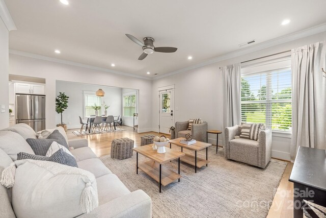 5305 Tarrywood Ln, Charlotte, NC 28205 - living room with light wood finished floors, a ceiling fan, ornamental molding, and recessed lighting