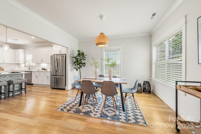 5305 Tarrywood Ln, Charlotte, NC 28205 - dining room featuring light wood finished floors and ornamental molding
