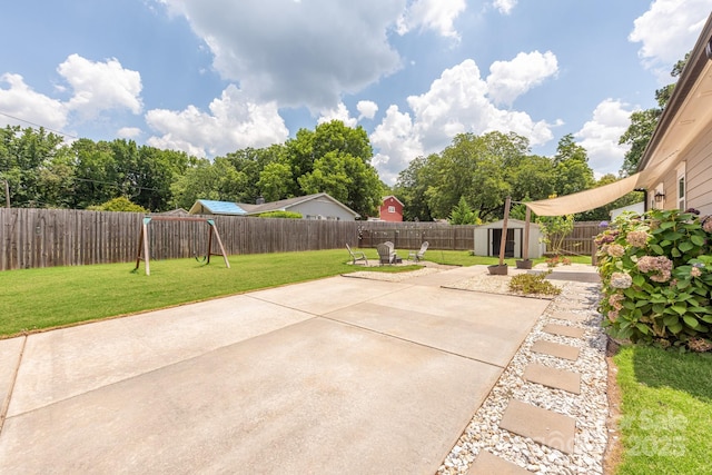 5305 Tarrywood Ln, Charlotte, NC 28205 - fenced backyard with a shed, a patio area, and a playground