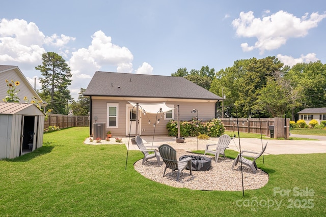 5305 Tarrywood Ln, Charlotte, NC 28205 - rear view of house featuring an outdoor fire pit, a shed, a fenced backyard, and a patio area