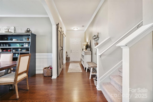 6029 Piscataway Ct, Rock Hill, SC 29732 - foyer entrance featuring a barn door, stairs, crown molding, dark wood finished floors, and arched walkways