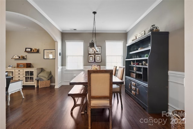 6029 Piscataway Ct, Rock Hill, SC 29732 - dining space featuring arched walkways, dark wood finished floors, a wainscoted wall, and crown molding