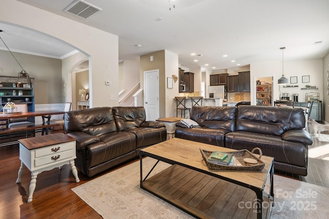 6029 Piscataway Ct, Rock Hill, SC 29732 - living room featuring arched walkways, wood finished floors, stairs, recessed lighting, and crown molding