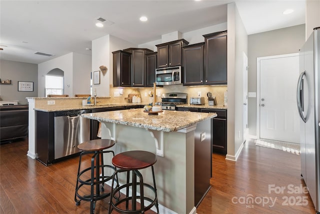 6029 Piscataway Ct, Rock Hill, SC 29732 - kitchen with stainless steel appliances, dark wood finished floors, tasteful backsplash, light stone countertops, and recessed lighting