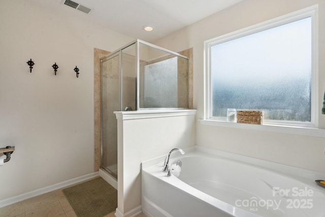 6029 Piscataway Ct, Rock Hill, SC 29732 - bathroom featuring a garden tub, a shower stall, and tile patterned flooring