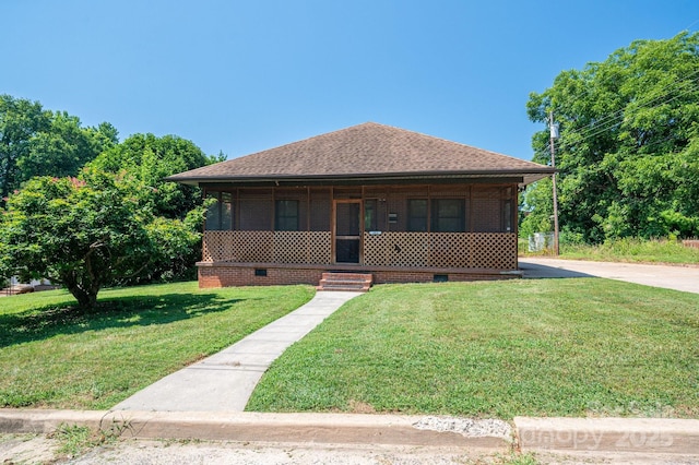 302 Planetree Dr, Belmont, NC 28012 - bungalow-style home featuring a front lawn, a shingled roof, and a sunroom