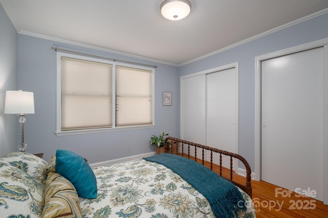 302 Planetree Dr, Belmont, NC 28012 - bedroom featuring wood finished floors, ornamental molding, and two closets