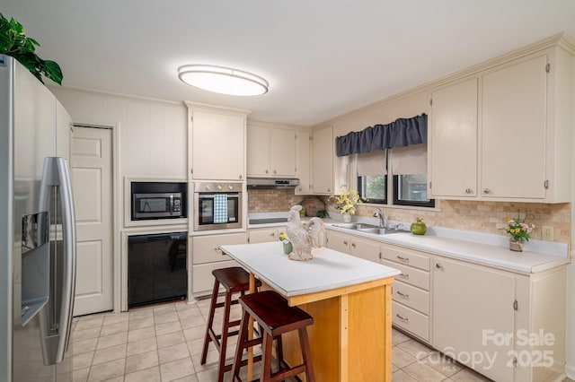 302 Planetree Dr, Belmont, NC 28012 - kitchen featuring stainless steel appliances, light tile patterned flooring, light countertops, tasteful backsplash, and a kitchen island