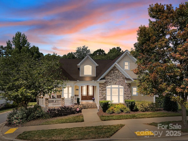 3211 Keady Mill Loop, Kannapolis, NC 28081 - view of front of house with stone siding, a porch, and french doors