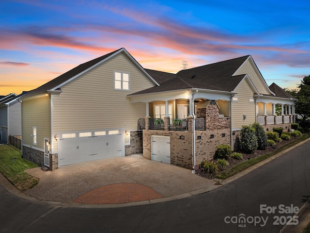 3211 Keady Mill Loop, Kannapolis, NC 28081 - view of front facade featuring a garage, concrete driveway, a balcony, a shingled roof, and stone siding