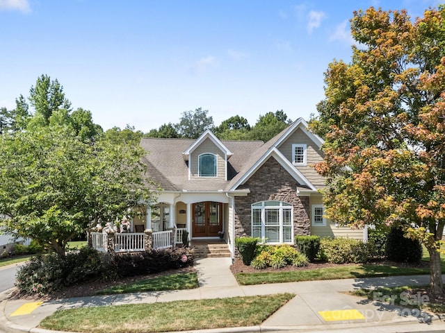 3211 Keady Mill Loop, Kannapolis, NC 28081 - view of front of home with stone siding, covered porch, french doors, and a shingled roof