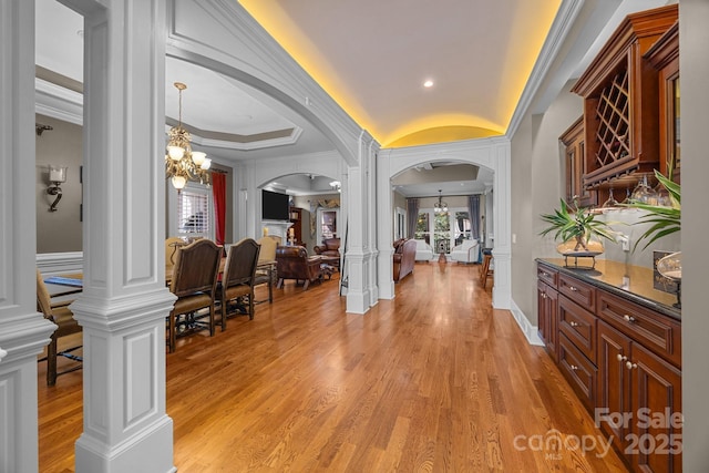 3211 Keady Mill Loop, Kannapolis, NC 28081 - foyer with arched walkways, a chandelier, ornate columns, light wood-style floors, and crown molding