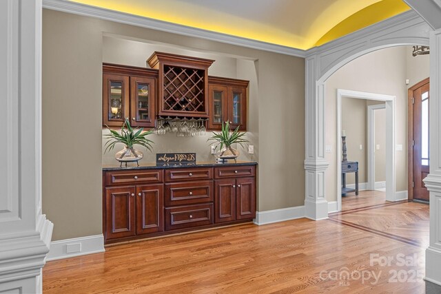 3211 Keady Mill Loop, Kannapolis, NC 28081 - indoor dry bar with light wood-style floors, arched walkways, vaulted ceiling, and ornate columns