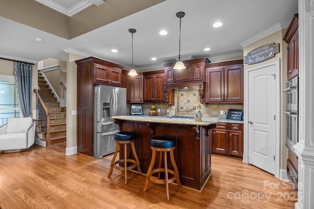 3211 Keady Mill Loop, Kannapolis, NC 28081 - kitchen featuring appliances with stainless steel finishes, a kitchen breakfast bar, ornamental molding, light wood-type flooring, and tasteful backsplash