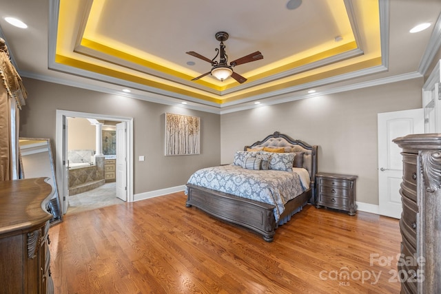 3211 Keady Mill Loop, Kannapolis, NC 28081 - bedroom featuring a tray ceiling, ornamental molding, light wood-style floors, and ensuite bathroom