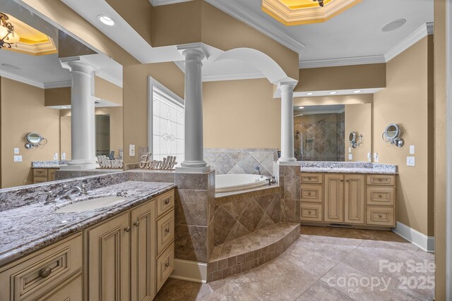 3211 Keady Mill Loop, Kannapolis, NC 28081 - bathroom featuring decorative columns, two vanities, a garden tub, tiled shower, and crown molding