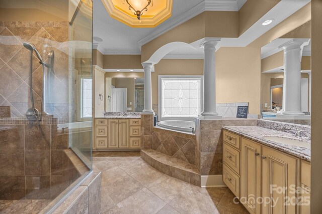 3211 Keady Mill Loop, Kannapolis, NC 28081 - bathroom featuring decorative columns, two vanities, a garden tub, tiled shower, and crown molding