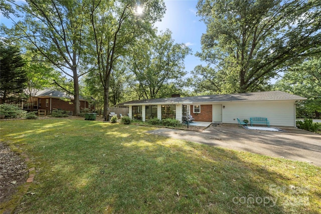 725 Plantation Rd, Lancaster, SC 29720 - ranch-style house with a front yard, brick siding, a chimney, and driveway