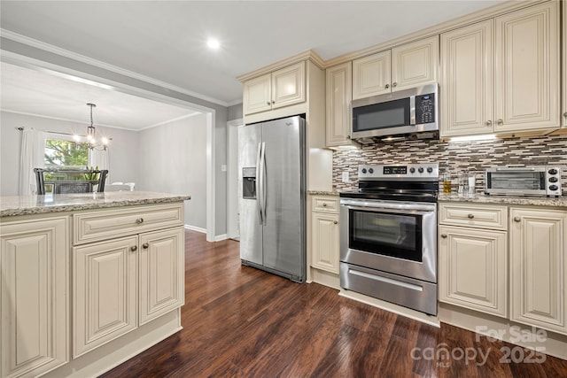 725 Plantation Rd, Lancaster, SC 29720 - kitchen with appliances with stainless steel finishes, cream cabinetry, dark wood finished floors, backsplash, and a chandelier