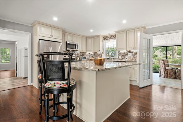 725 Plantation Rd, Lancaster, SC 29720 - kitchen with appliances with stainless steel finishes, cream cabinets, plenty of natural light, crown molding, and recessed lighting
