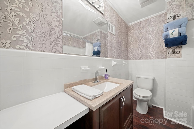 725 Plantation Rd, Lancaster, SC 29720 - bathroom featuring wallpapered walls, vanity, wood finished floors, wainscoting, and tile walls