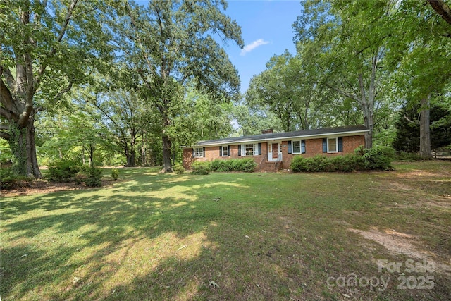 725 Plantation Rd, Lancaster, SC 29720 - ranch-style house with brick siding, a front yard, and a chimney