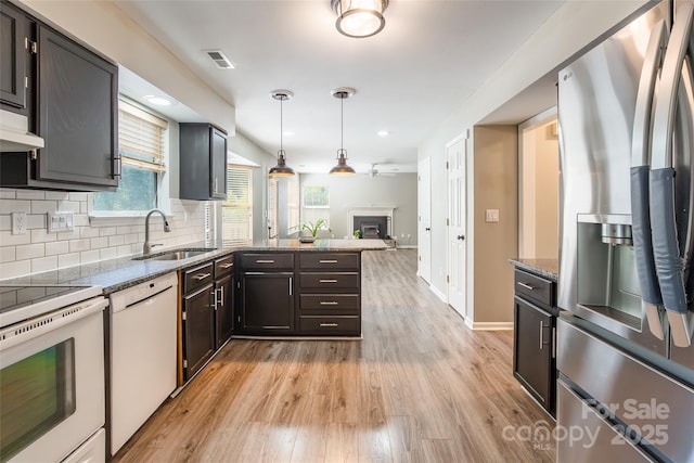 8909 Raven Park Dr, Charlotte, NC 28216 - kitchen with white appliances, open floor plan, light wood-style flooring, light stone counters, and recessed lighting