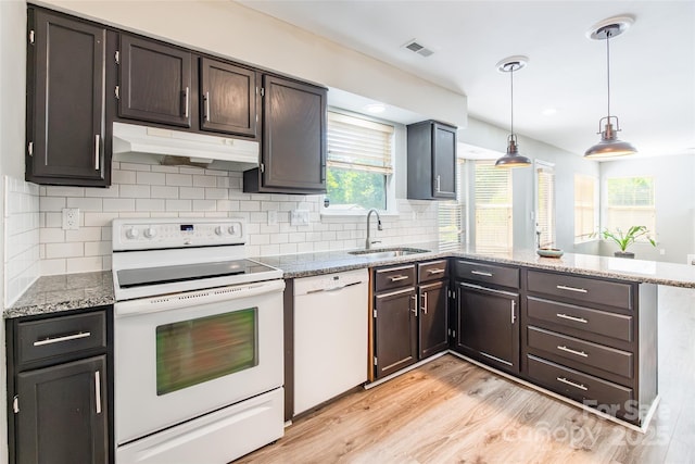 8909 Raven Park Dr, Charlotte, NC 28216 - kitchen featuring white appliances, a peninsula, under cabinet range hood, light wood finished floors, and light stone countertops