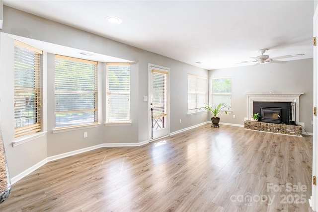 8909 Raven Park Dr, Charlotte, NC 28216 - unfurnished living room featuring wood finished floors, ceiling fan, and a brick fireplace