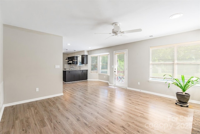 8909 Raven Park Dr, Charlotte, NC 28216 - unfurnished living room with ceiling fan, light wood finished floors, and recessed lighting