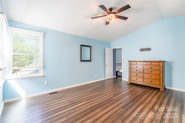 8909 Raven Park Dr, Charlotte, NC 28216 - unfurnished bedroom with vaulted ceiling, wood finished floors, a textured ceiling, and a ceiling fan