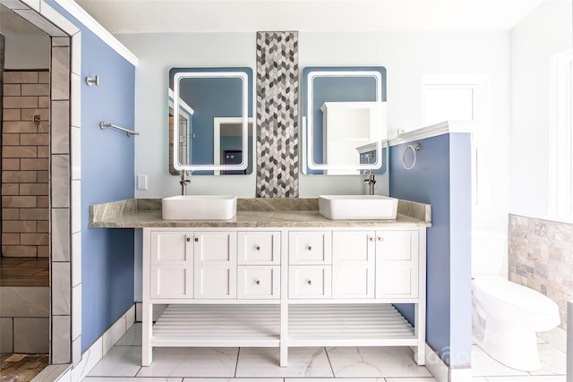8909 Raven Park Dr, Charlotte, NC 28216 - full bathroom featuring double vanity, tiled shower, and marble look tile flooring