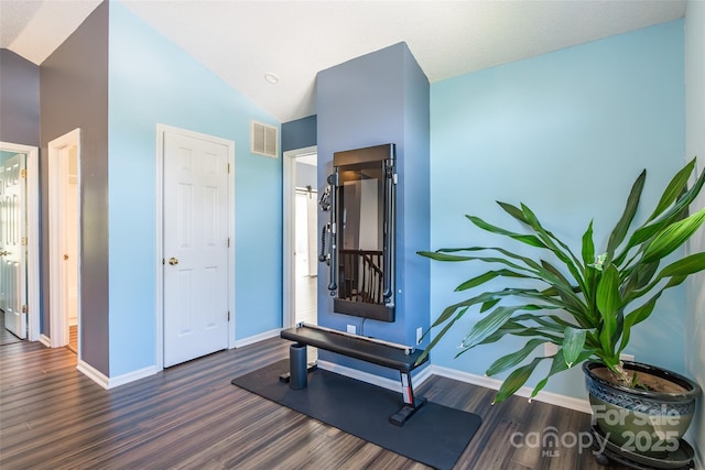8909 Raven Park Dr, Charlotte, NC 28216 - workout room with wood finished floors and vaulted ceiling