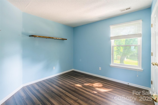 8909 Raven Park Dr, Charlotte, NC 28216 - unfurnished room featuring a textured ceiling and dark wood-style flooring