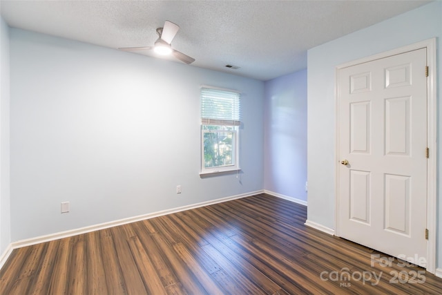 8909 Raven Park Dr, Charlotte, NC 28216 - empty room with dark wood-type flooring, ceiling fan, and a textured ceiling