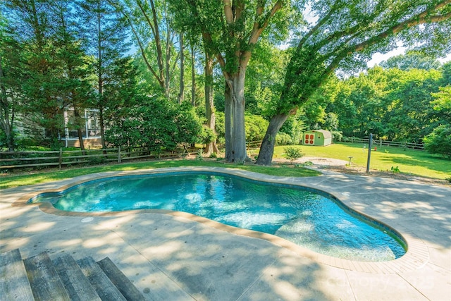 8909 Raven Park Dr, Charlotte, NC 28216 - view of pool with a patio, a storage unit, a fenced backyard, and view of wooded area