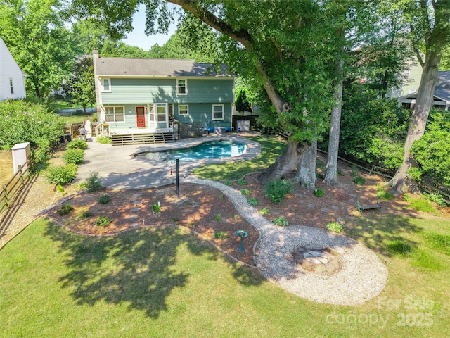 8909 Raven Park Dr, Charlotte, NC 28216 - rear view of house with a deck, an outdoor pool, and a chimney