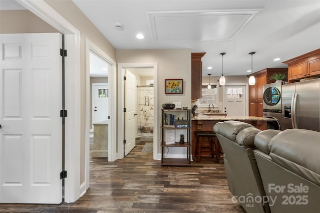 8333 Catawba Cove Dr, Belmont, NC 28012 - living area featuring attic access, stacked washer / dryer, dark wood-type flooring, and recessed lighting