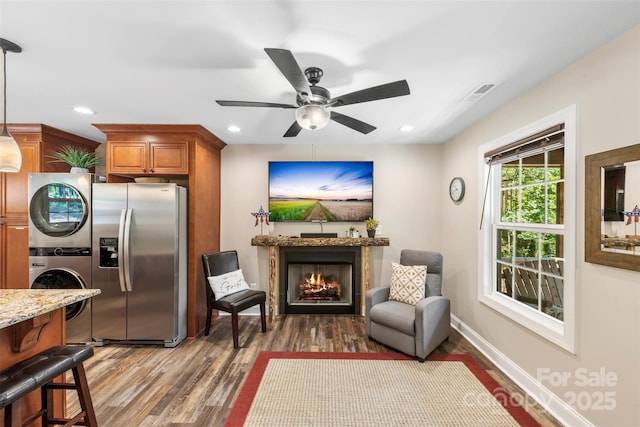 8333 Catawba Cove Dr, Belmont, NC 28012 - living room featuring estacked washer and dryer, a lit fireplace, wood finished floors, a ceiling fan, and recessed lighting