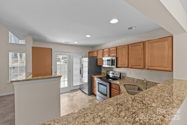 348 Tidmarsh Ct NW, Concord, NC 28027 - kitchen with stainless steel appliances, light stone countertops, a peninsula, and recessed lighting