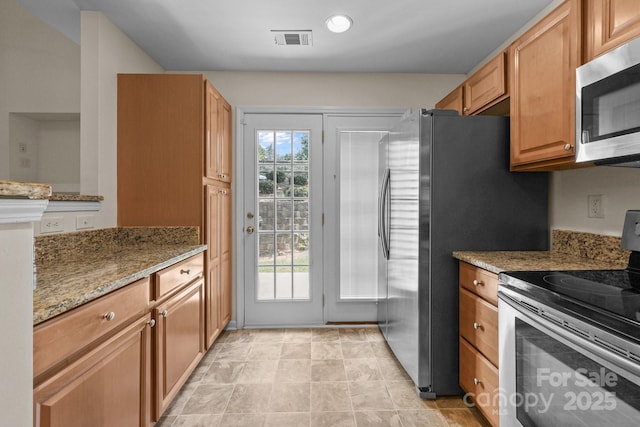 348 Tidmarsh Ct NW, Concord, NC 28027 - kitchen with stainless steel appliances, light stone counters, brown cabinetry, and recessed lighting