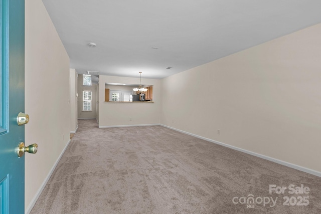 348 Tidmarsh Ct NW, Concord, NC 28027 - unfurnished living room featuring a chandelier and carpet