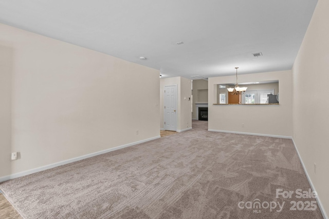 348 Tidmarsh Ct NW, Concord, NC 28027 - unfurnished living room featuring a chandelier and carpet floors