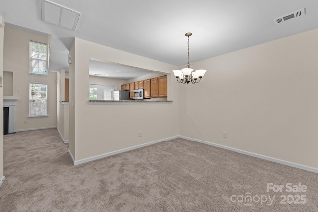 348 Tidmarsh Ct NW, Concord, NC 28027 - unfurnished dining area with a chandelier and light colored carpet