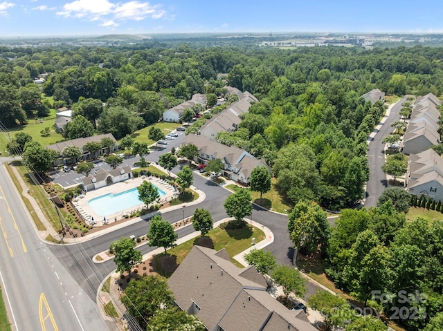 348 Tidmarsh Ct NW, Concord, NC 28027 - aerial perspective of suburban area with a pool and a heavily wooded area