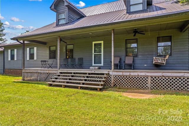 144 J And W Rd, Olin, NC 28660 - back of property with a porch, a ceiling fan, a metal roof, and a yard